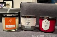 All three candles side-by-side on sofa