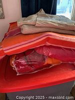 All textiles stacked on storage tote