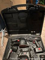 Open case showing all cordless tools and accessories