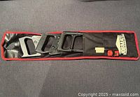 Case opened showing three black handles and accessories