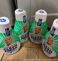Four Mr. Clean Clean Freak refill bottles grouped together
