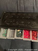 Top view showing black cabinet and five drawers with green, empty, multicolour wire connectors