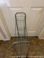 Top view of narrow metal wire cart showing handle and shelves