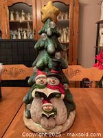 Full view of snowman family figurine and tree