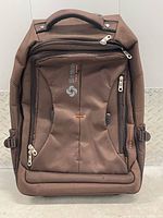 Front view showing overall luggage, wheels, handle, compartments