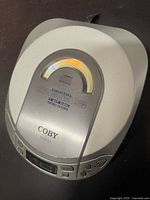 Top view of Coby CX-CD101 portable CD player showing digital DBBS branding