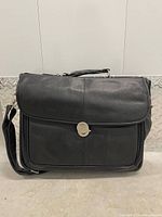 Front view of black Dell messenger bag showing flap and strap