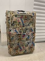 Front view of suitcase showing collage pattern and front pocket