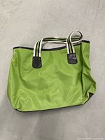Front view of neon green nylon tote showing handles and trim