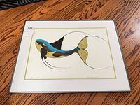 Full view of framed print on wood floor