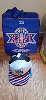 Two GTE Super Bowl XXVI seat cushions and two caps