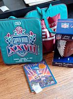 Seat cushion, stadium seat, boxed football, program visible