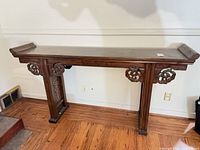 Front view of Chinese wooden altar table showing top, legs, carved brackets