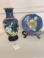 Cloisonné vase on stand and plate on stand side by side