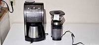 Cuisinart Grind & Brew coffeemaker and burr grinder side by side on table
