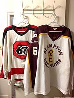 Front view of both jerseys hanging side by side