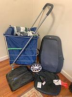 Overall lot showing shopping cart loaded with hangers, massager cushions