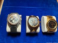 Front view showing all three Original Grain watches on cushions