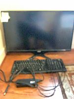 Front view of Acer monitor with Logitech keyboard and cables