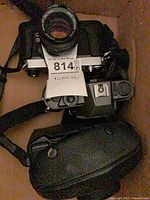 Three Pentax cameras and case in box