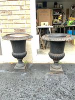 front view of both cast iron urns on driveway