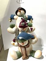 Stacked stuffed snowmen figure with three snowmen and bells, about 2 ft tall