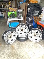 Four steel rims standing on floor