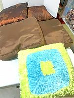 Group of five pillows showing colors and textures