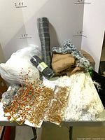 Assorted garlands, mesh rolls and burlap on table