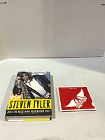 Front view of Steven Tyler autobiography and Aerosmith CD front cover