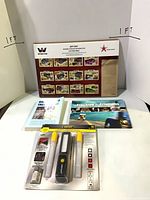 All four items grouped: LED light kit, Western Star calendar, two books