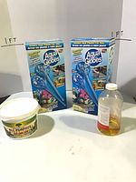 Two retail boxes Aqua Globes, fertilizer tub, hummingbird food bottle displayed