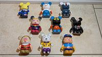 Group shot of nine Vinylmation figures arranged in three rows