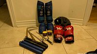 All items grouped: sai, nunchaku, kama, shin and instep guards, head guard, boxing gloves, hand wraps