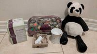 Full lot: box, zip pouch with wax samples, panda plush, ceramic warmer top, plug base in molded tray