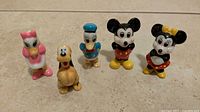 Group shot of five Disney ceramic figurines