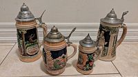 Four steins grouped showing relative sizes and designs