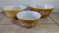 Three nesting Pyrex Butterfly Gold bowls external pattern visible