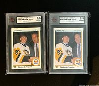 Front of both graded cards showing player image, grade and labels