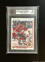 Front of KSA-slabbed Jeremy Roenick rookie card showing grade 8 label and front artwork