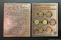 Open binder showing six coins and information sheet