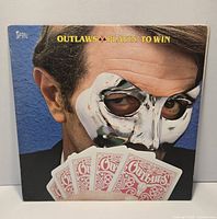 Front cover of Outlaws Playin' to Win LP showing artwork and edge wear