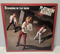Front cover of Platinum Blonde Standing in the Dark LP showing artwork and wear