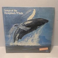 Front cover of Songs of the Humpback Whale LP showing artwork, shrink wrap and sticker