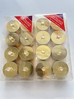 Two sealed packs of eight gold LED tealights each, front view
