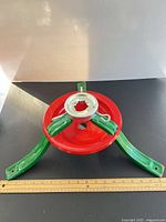 Top view of red reservoir and green legs with silver collar