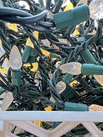 Close view of green-wire strands with clear faceted bulbs