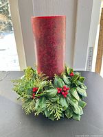 Front view of candle with greenery wreath