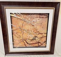 Front view of framed bird and branches print