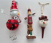All three golf-themed ornaments side by side